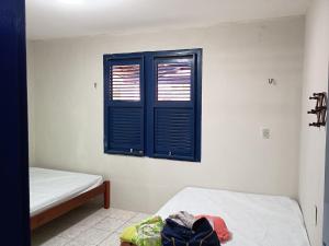 a room with two beds and a window at Casa Bem-ti-vi in Aquiraz