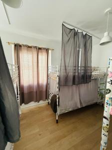 a room with two bunk beds and curtains at 70's Hostel in Ericeira