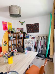 a room with a table and surfboards in it at 70's Hostel in Ericeira