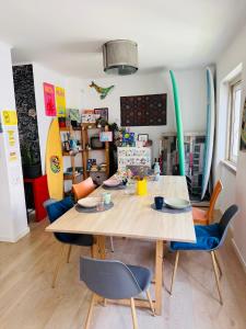 a dining room with a wooden table and chairs at 70's Hostel in Ericeira