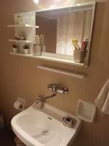 a bathroom with a sink and a mirror at Floor in Alexandroupoli