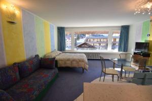 una sala de estar con un sofá y una mesa en RAINALTER Studio 14A Centrale, en Madonna di Campiglio