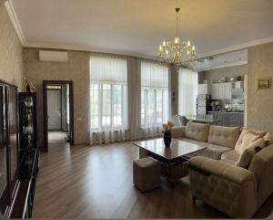 a living room with a couch and a table at Halal House Vip in Qusar