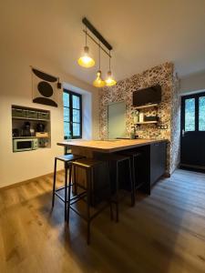a kitchen with a wooden table in a room at Le Chanaz 89 in Chanaz