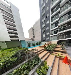 a courtyard in a building with two tall buildings at Urbano Apartments in Lima