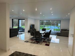 a living room with a dining table and chairs at Apartment G1 in Neunkirchen