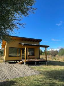 a tiny house sitting on top of a field at Cabaña Lilacho in Cholila