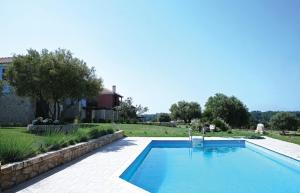 a large blue swimming pool in a yard at Michaela in Kassandra
