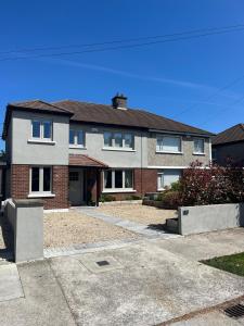 a house with a driveway in front of it at Luxury 4 Bedroom Home, South Dublin in Blackrock