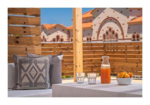 a table with two glasses and a bottle of juice at Baulus Yard Luxury I in Heraklio Town