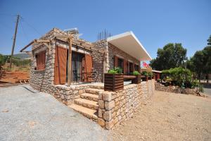 a small stone house with a stone wall at Casa Gustosa Μονεμβασιά in Monemvasia +21 photos