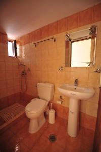 a bathroom with a toilet and a sink at Casa Gustosa Μονεμβασιά in Monemvasia