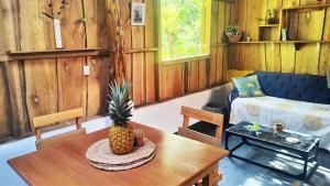 a living room with a pineapple sitting on a table at Wild Nest Chirripo in Rivas