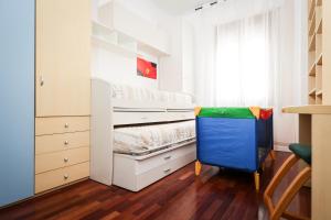 a small bedroom with a bed and a dresser at Modena Visit Apartment in Modena
