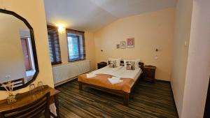 a bedroom with a bed and a flat screen tv at Hotel Izvorat Arda - Хотел Изворът Арда in Arda +31 photos