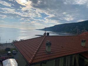 a view of the ocean from the roof of a building at Casa Ginny in Ospedaletti