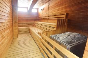 a sauna with wooden walls and wooden floors at MEANDER THERMAL & SKI REZORT ORAVICE in Oravice