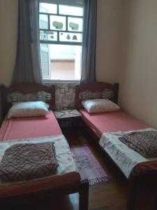 three beds in a room with a window at Hostel Baladi in Socorro