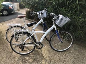 two bikes parked next to each other on a sidewalk at Le Petit Bois in Sainte-Marie-de-Ré