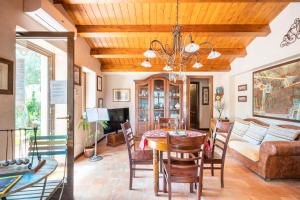 a dining room with a table and a couch at Villarose in Castelbuono
