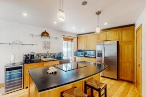 a kitchen with wooden cabinets and a black counter top at Eagle-Vail Ski/Golf Retreat in Dowds Junction
