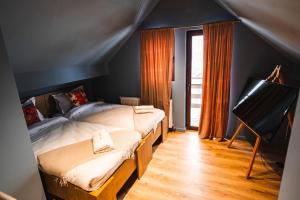 a bedroom with two twin beds and a television at The Vardo: Elegant Villa in Predelut in Bran