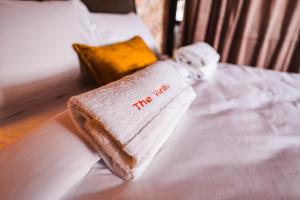 a towel on a bed with the words the mess on it at The Vardo: Elegant Villa in Predelut in Bran +75 photos