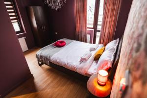 a bedroom with a bed with two pillows on it at The Vardo: Elegant Villa in Predelut in Bran