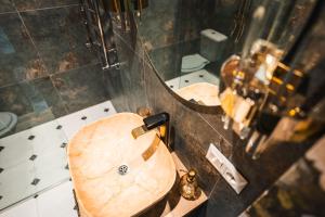a bathroom with a wooden sink and a mirror at The Vardo - Elegant Villa in Predelut in Bran +75 photos