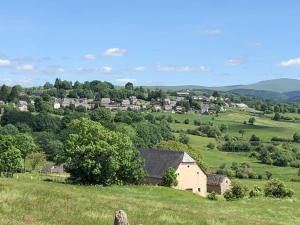 a view of a small village in a green field at Maison récente type traditionnelle 9 couchages in Trizac