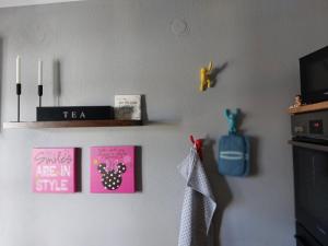 a room with some pictures on the wall at Spatzennest 2 in Welschneudorf