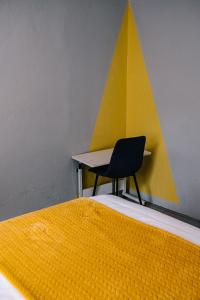 a bedroom with a desk and a chair next to a bed at Delightful 1 Bedroom Flat in Germiston with WI-FI in Germiston