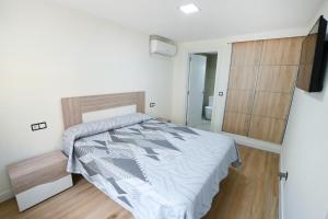 a bedroom with a bed and a door to a bathroom at Etonnante Villa Carrio à Calpe by LG Home in Calpe