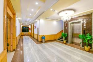 a hallway of a building with a chandelier at Hotel Chhutuk Heights in Kargil