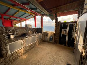 a kitchen with a stove and a counter top at Glamping Spa & Coffee Tour in Medellín
