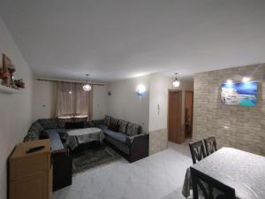 a living room with a couch and a table at appartement plage Bouznika in Bouznika