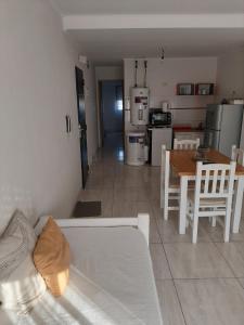 a living room with a white couch and a table at Ayres Apart in Chivilcoy +11 photos