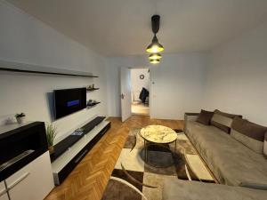 a living room with a couch and a table at Traian apartaments in Râmnicu Vâlcea