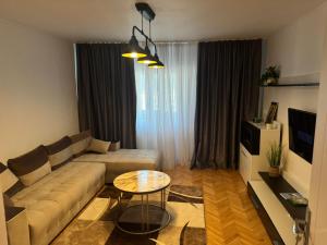 a living room with a couch and a table at Traian apartaments in Râmnicu Vâlcea