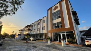 a building with a parking lot in front of it at Hotel Coronado Inn in Playa Coronado