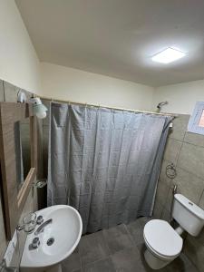 a bathroom with a sink and a toilet and a shower at Cabañas Boutique La Soñada in Fiambalá