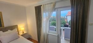 a bedroom with a bed and a large window at Apartmani Meri in Supetar +31 photos