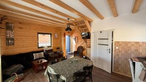 a living room with a table and a couch at Domki Wilcza B in Wilcza