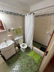 a bathroom with a toilet and a sink and a shower at Chalet Mar del Plata in Mar del Plata +24 photos