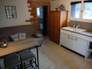 a kitchen and living room with a table and a couch at Appartement Verrens in Verrens-Arvey +2 photos