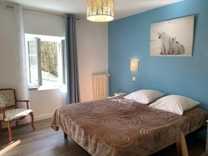 Postel nebo postele na pokoji v ubytování Le Moulin Bleu