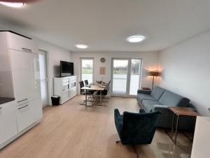 a living room with a couch and a table at Wera in Butjadingen +28 photos