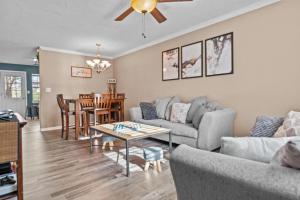 a living room with a couch and a table at Woodstone Retreat Condo right next to UGA golf course 2475 in Athens