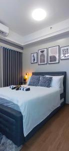 a bedroom with a large bed in a room at Santorini Condotel in Manila