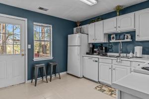 a kitchen with white cabinets and a white refrigerator at Woodstone Retreat Condo right next to UGA golf course 2475 in Athens +14 photos